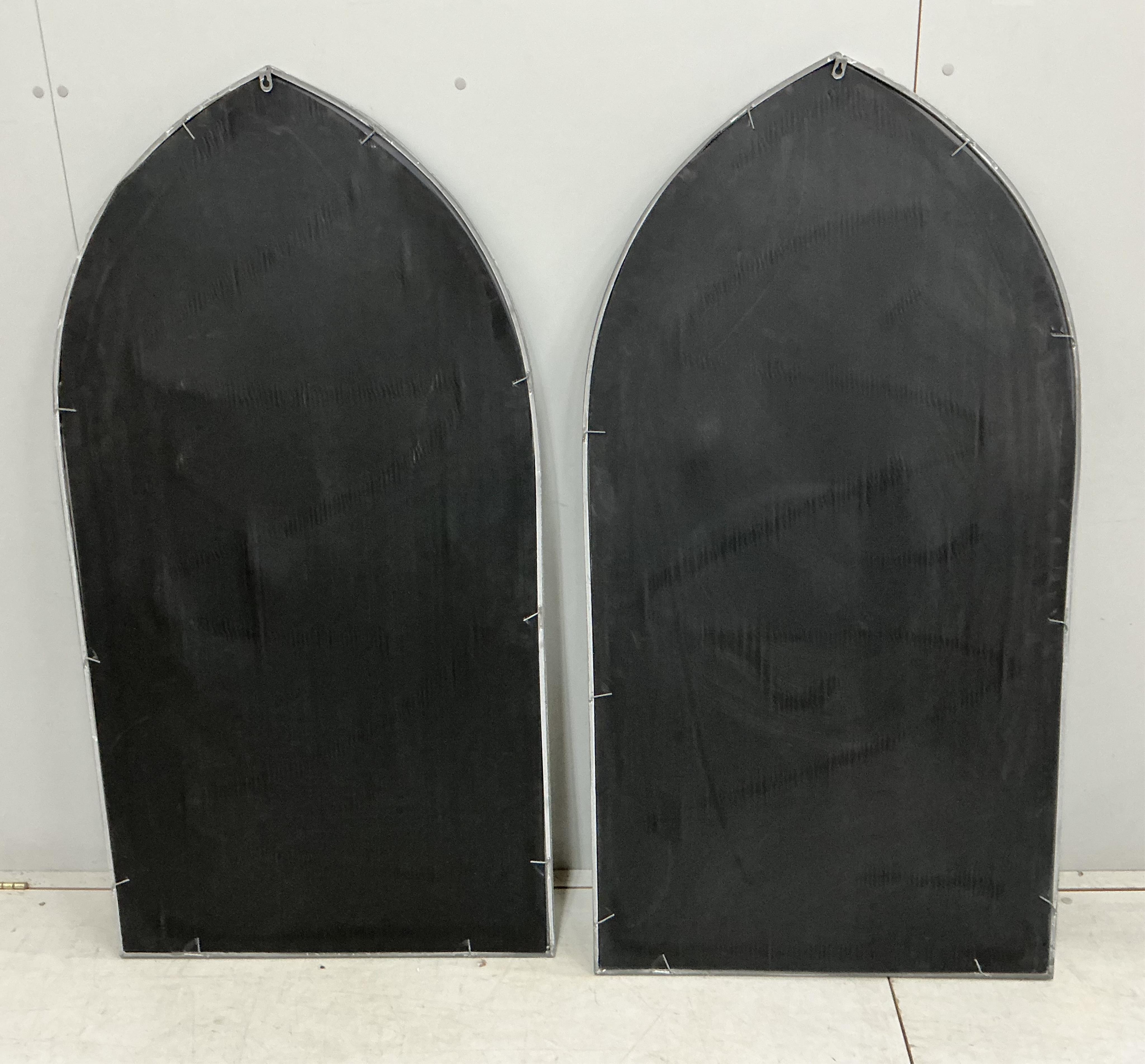 A pair of modern Gothic style arched window frame style wall mirrors, width 71cm, height 138cm